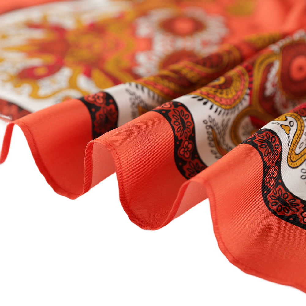 Close-up of the orange paisley silk scarf edge