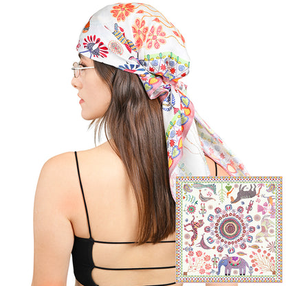 Model wearing the colorful animal print silk scarf as a head wrap