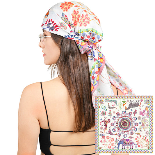 Model wearing the colorful animal print silk scarf as a head wrap
