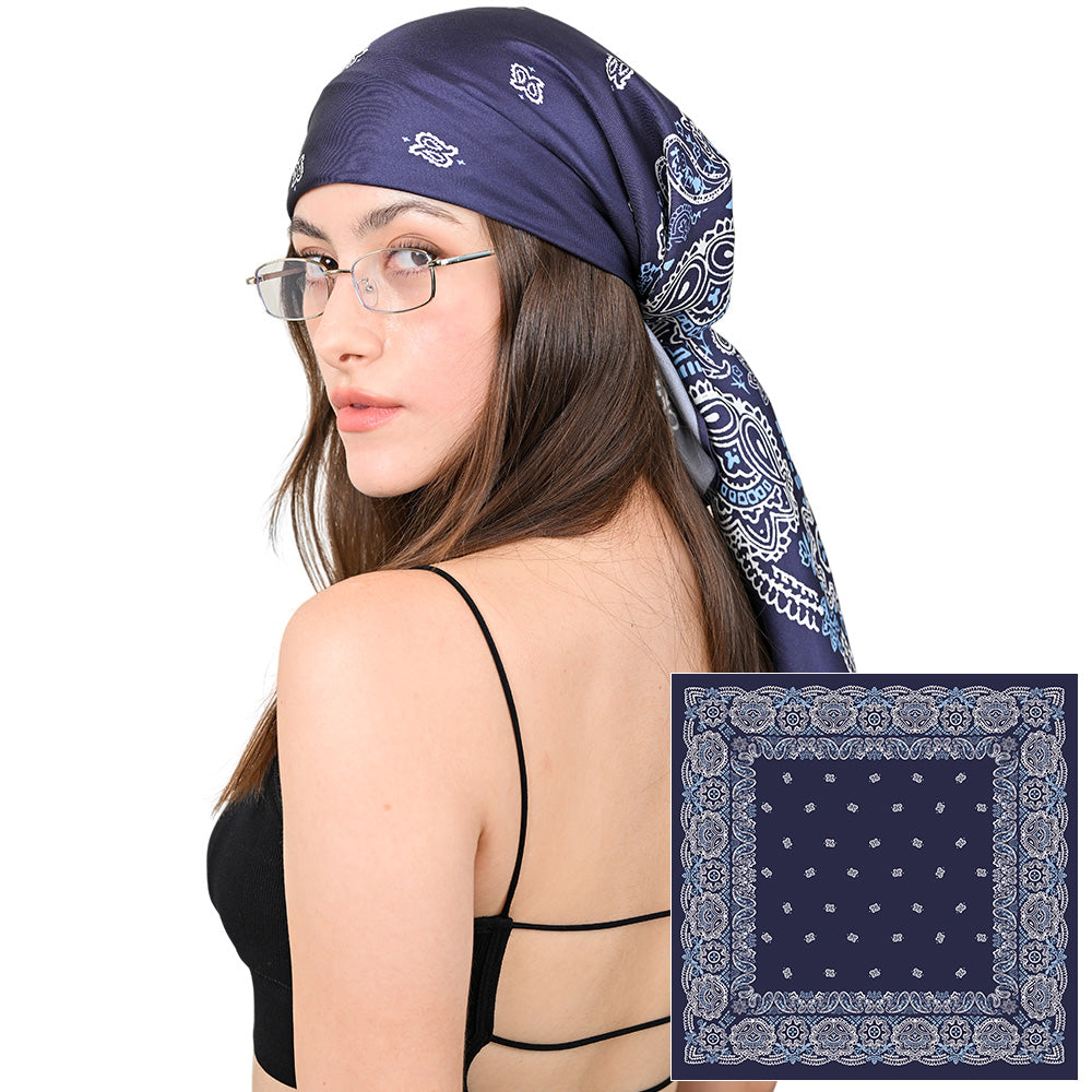 Model styling a navy and white paisley silk scarf as a headscarf