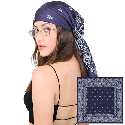 Model styling a navy and white paisley silk scarf as a headscarf