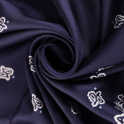 Close-up of the navy and white paisley silk scarf print