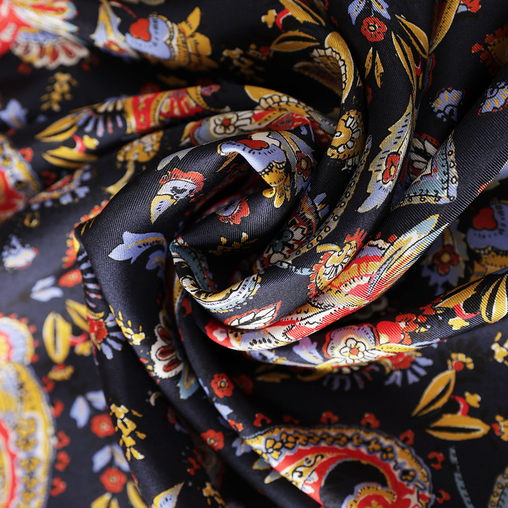 Close-up of the navy silk scarf's colorful paisley and floral print