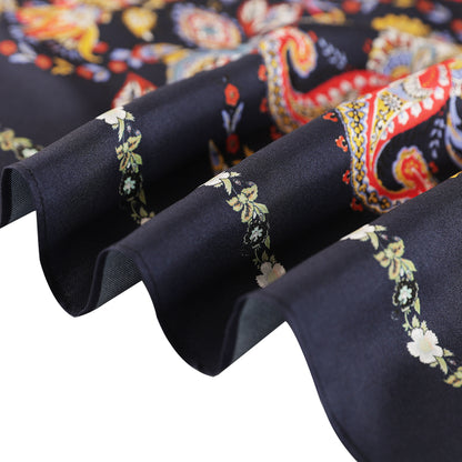 Close-up of the navy paisley silk scarf edge