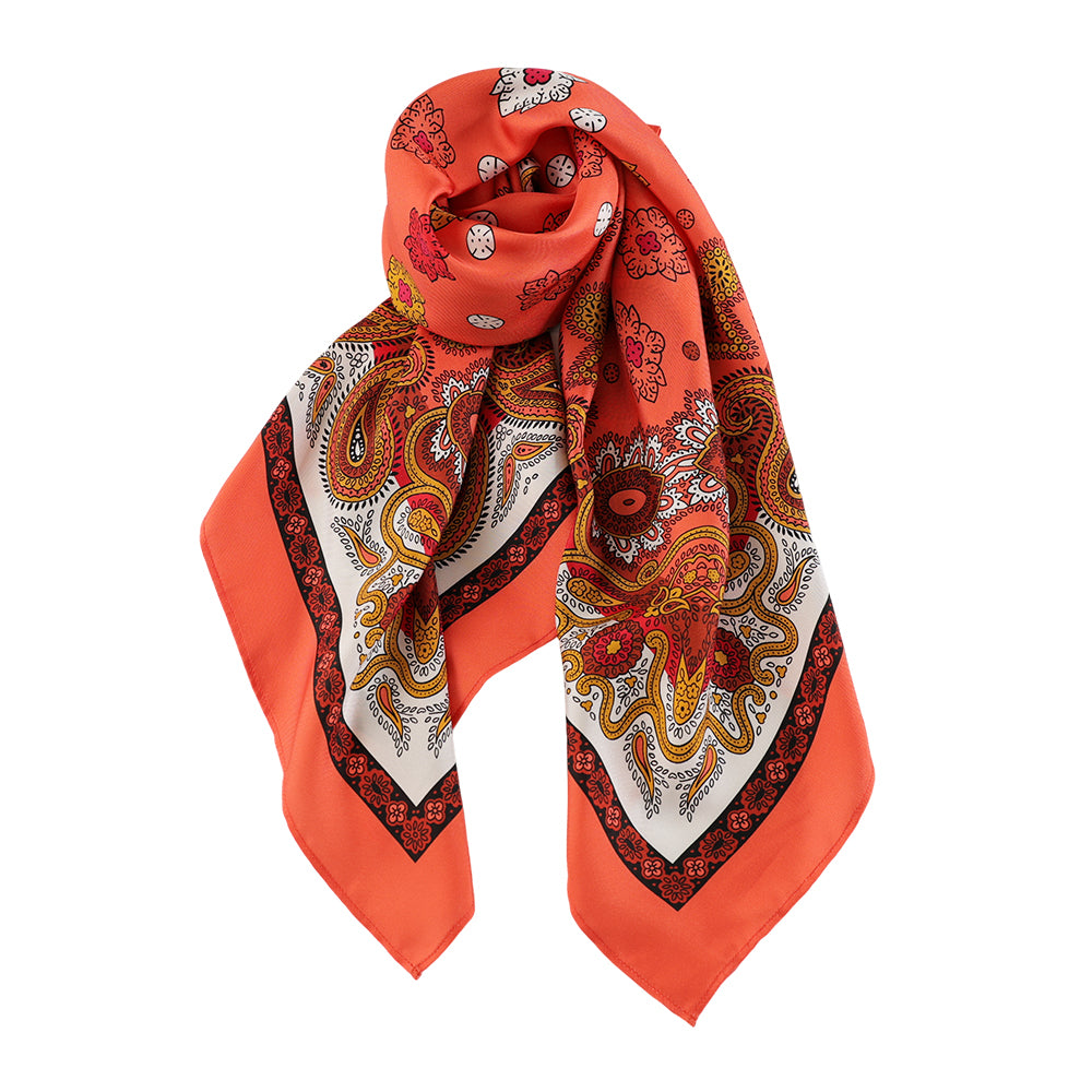 Draped styling of a vivid orange paisley silk scarf