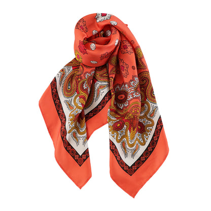Draped styling of a vivid orange paisley silk scarf