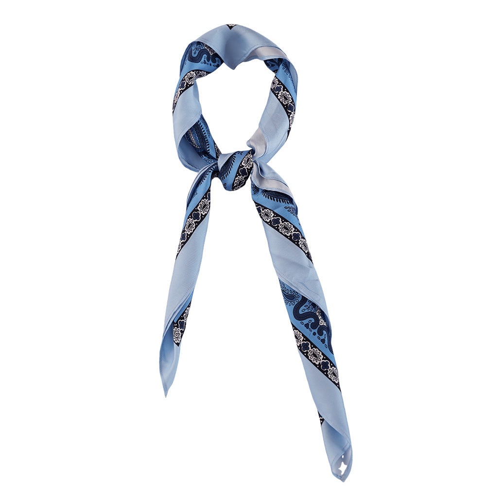 Light blue paisley silk scarf styled around the neck