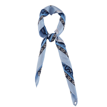 Light blue paisley silk scarf styled around the neck