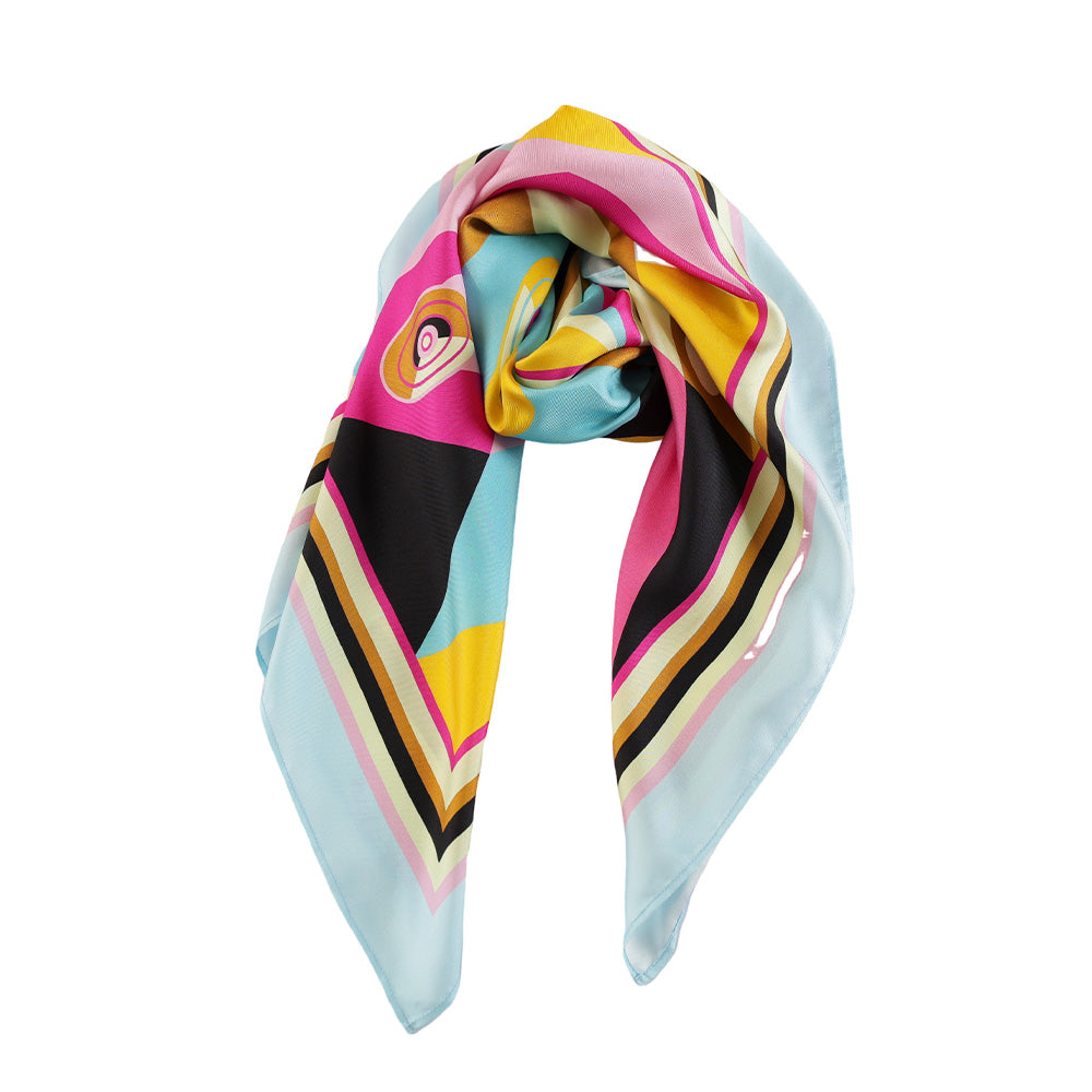 Draped styling of a multicolor geometric silk scarf